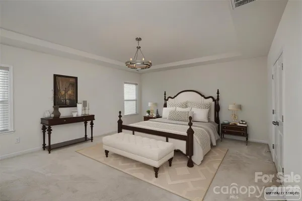 a bedroom with a bed and a couch