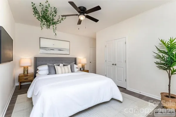 a bedroom with a bed and a potted plant