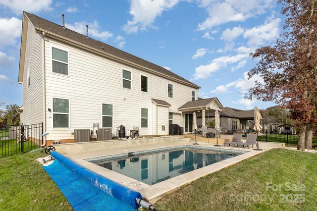 a view of a house with swimming pool and sitting area