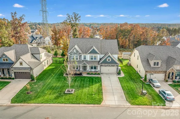 an aerial view of a house with a yard