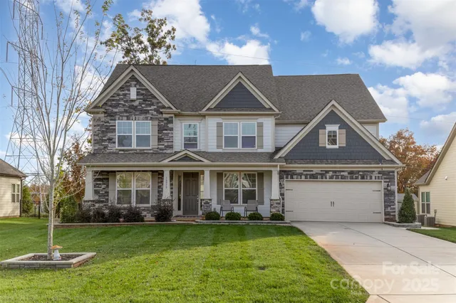 a living room with furniture a fireplace and a window