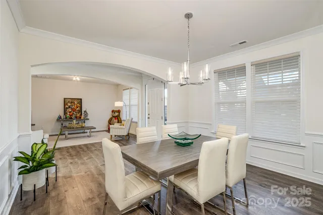 a front view of a house with a garden and plants