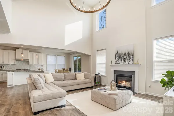 a living room with furniture a fireplace and a window