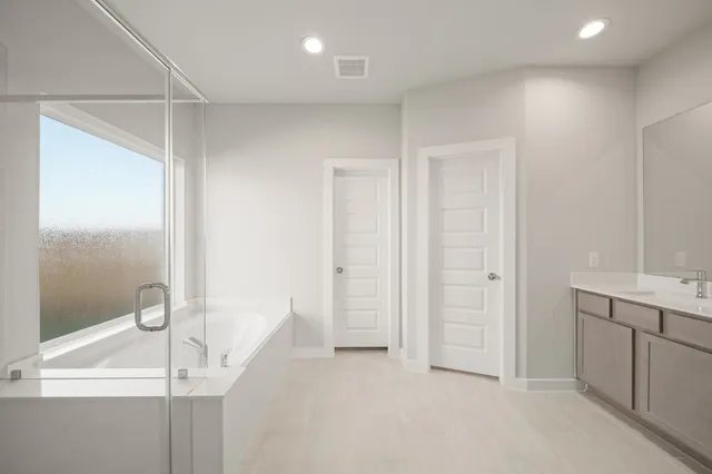 a bathroom with a bathtub shower and a sink