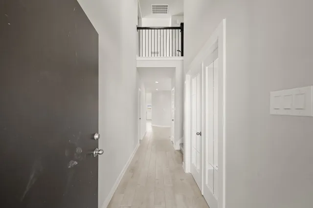 a view of a hallway with a door