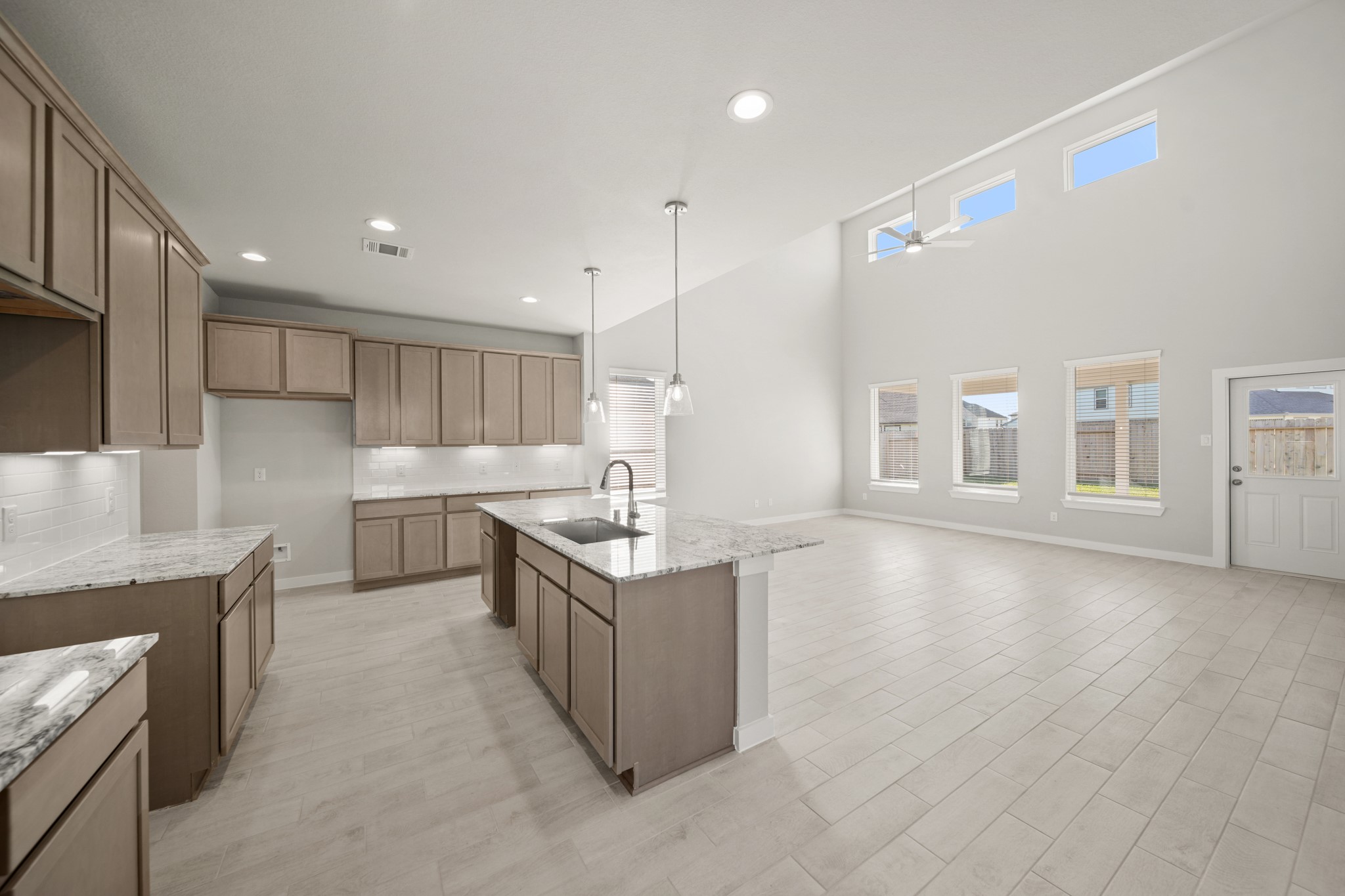643 Yard Master Trail Rosharon, TX 77583 - Photo 4 of 39 a kitchen with stainless steel appliances granite countertop a sink a stove and a refrigerator
