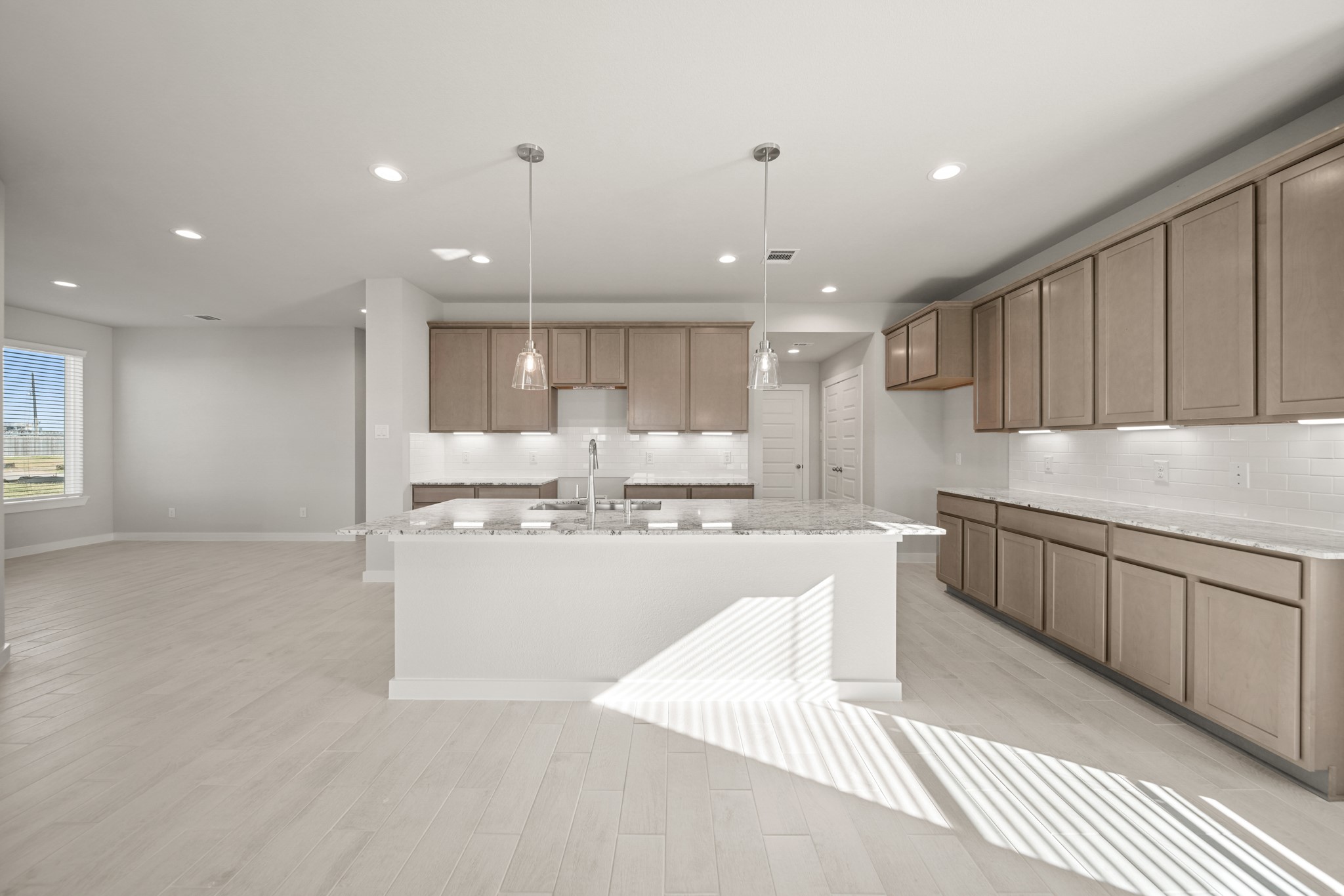 643 Yard Master Trail Rosharon, TX 77583 - Photo 6 of 39 a kitchen with kitchen island granite countertop wooden cabinets and white stainless steel appliances