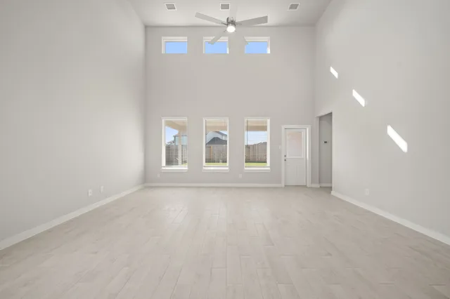 a view of a kitchen with refrigerator and windows