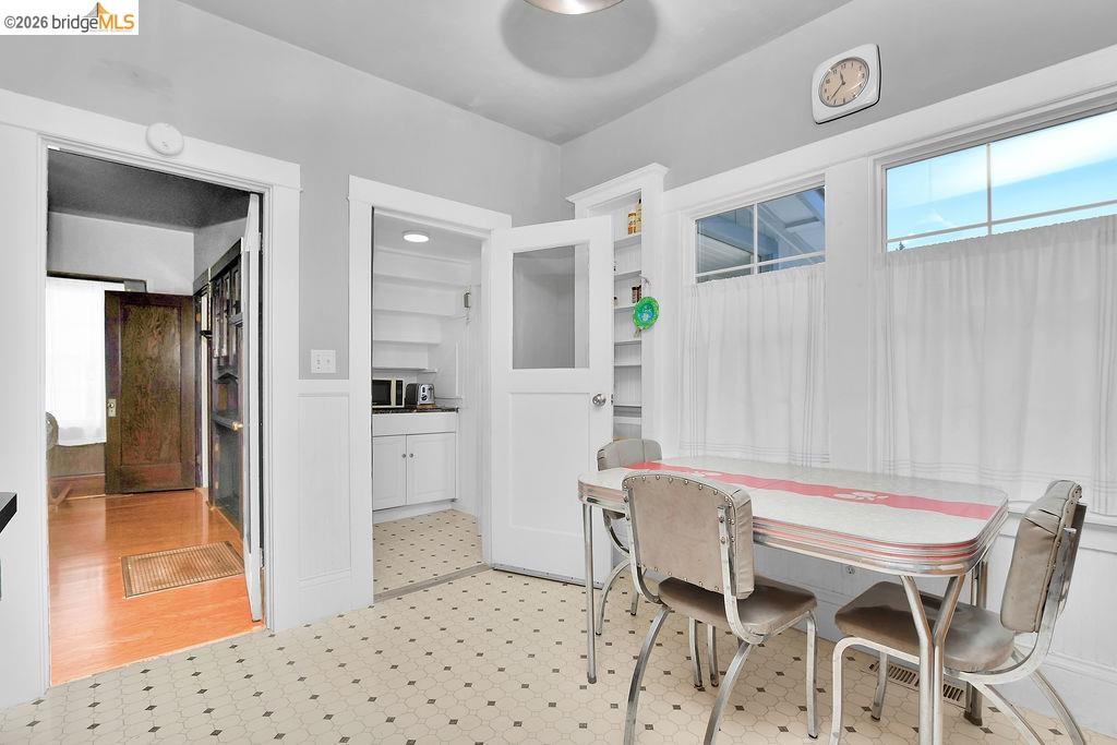 325 South 2nd Street Rio Vista, CA 94571 - Photo 15 of 33 Kitchen area featuring a hexagonal tile floor, white wainscoting, and multiple windows with white trim
