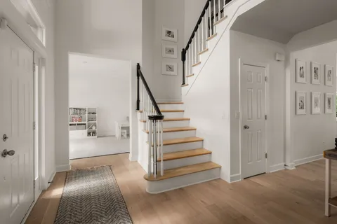 a view of entryway with furniture and wooden floor