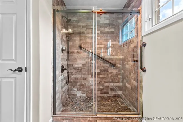 a bathroom with a glass shower door