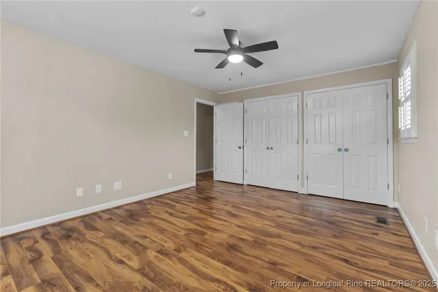 a view of an empty room and wooden floor