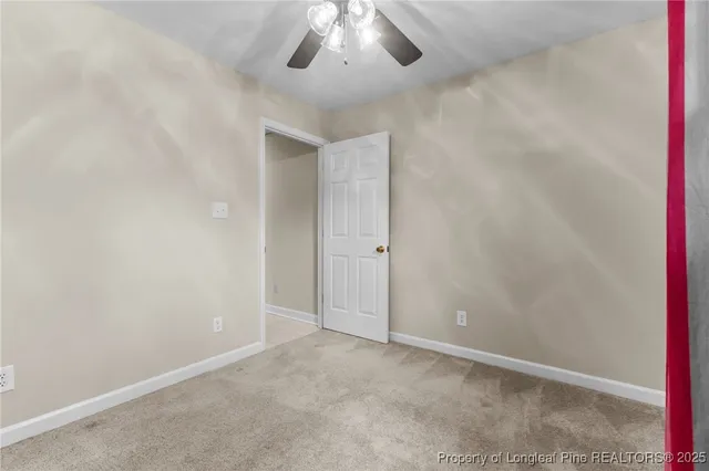 an empty room with a empty space and a ceiling fan