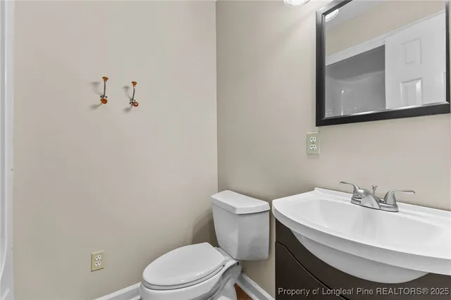a bathroom with a sink toilet and mirror