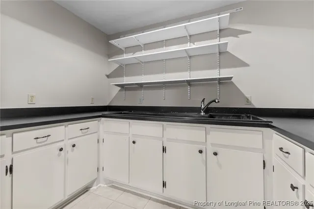 a view of a house with a yard and a garage