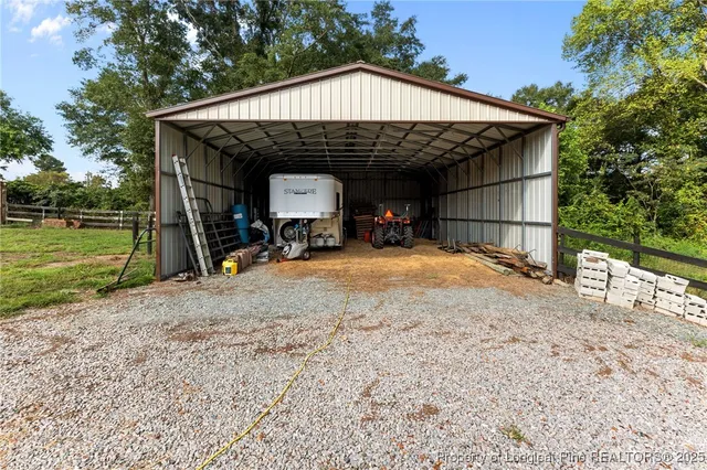 a view of backyard with table and chairs and potted plants