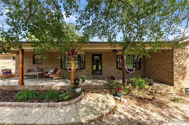 a view of house with yard and seating area