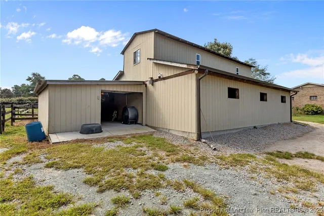 a view of a swimming pool with a yard and sitting area