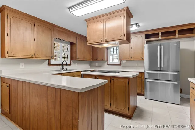 a kitchen with stainless steel appliances granite countertop a refrigerator and a sink