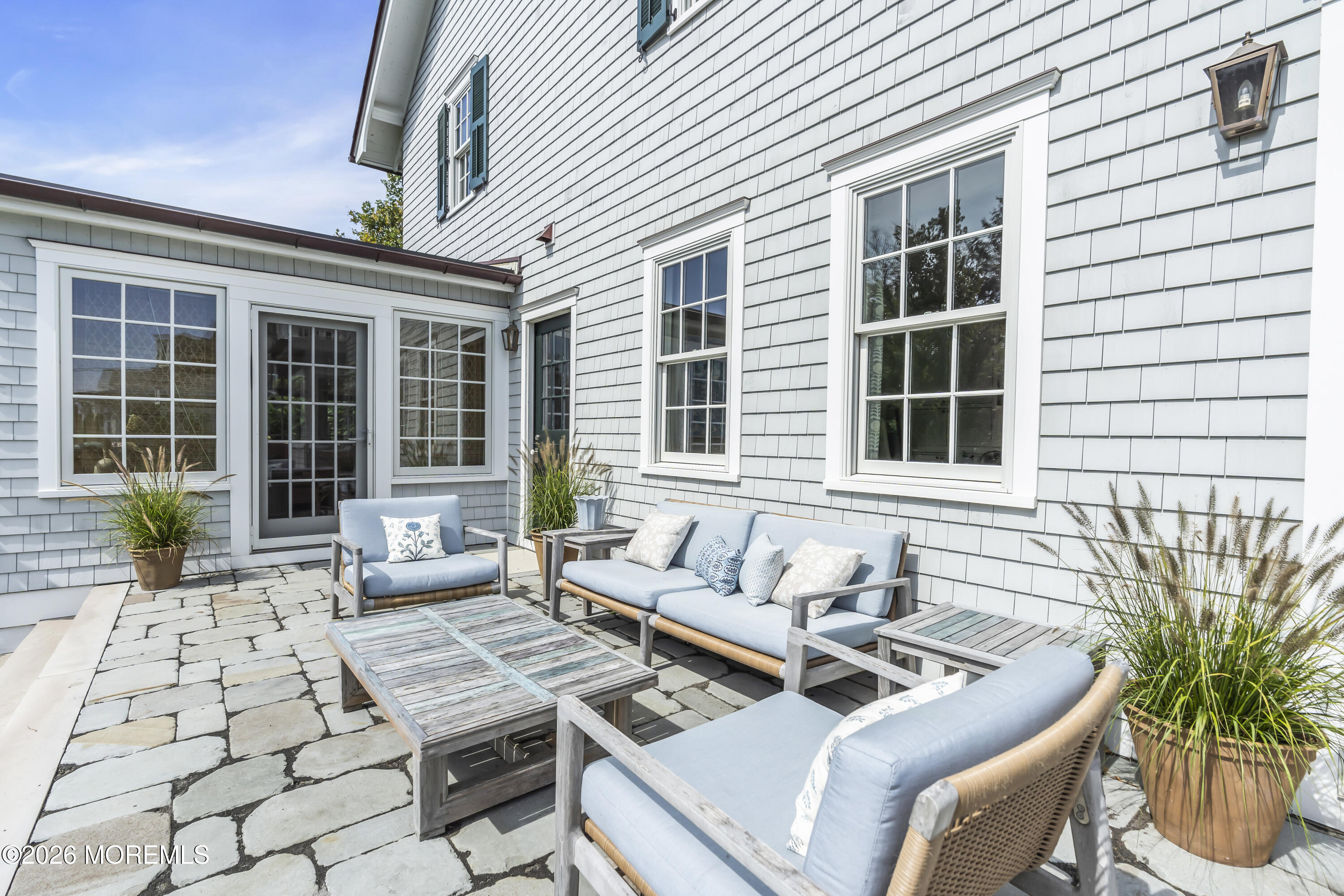 117 Madison Avenue Spring Lake, NJ 07762 - Photo 17 of 96 a view of a patio with couches table and chairs and potted plants