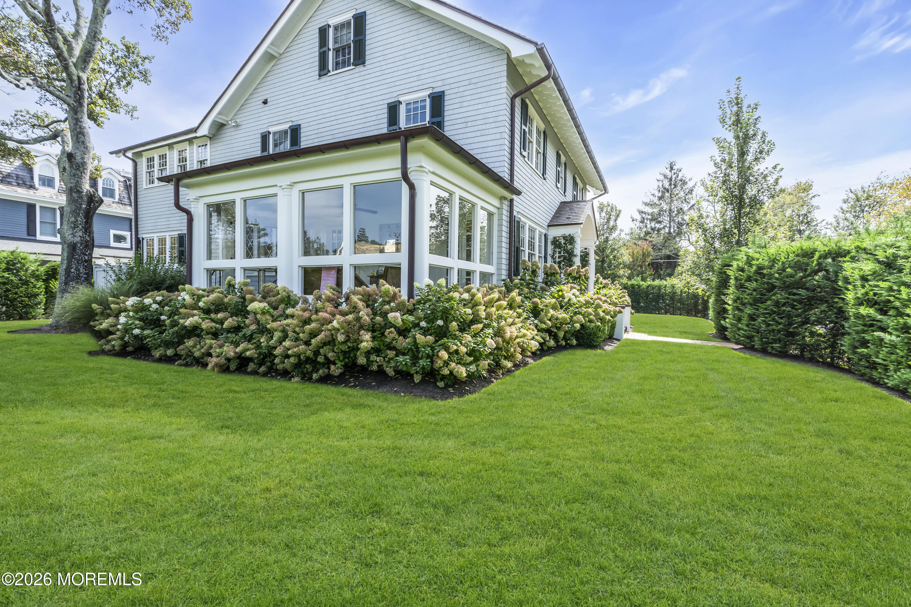 117 Madison Avenue Spring Lake, NJ 07762 - Photo 22 of 96 a view of a big yard in front of a brick house with plants