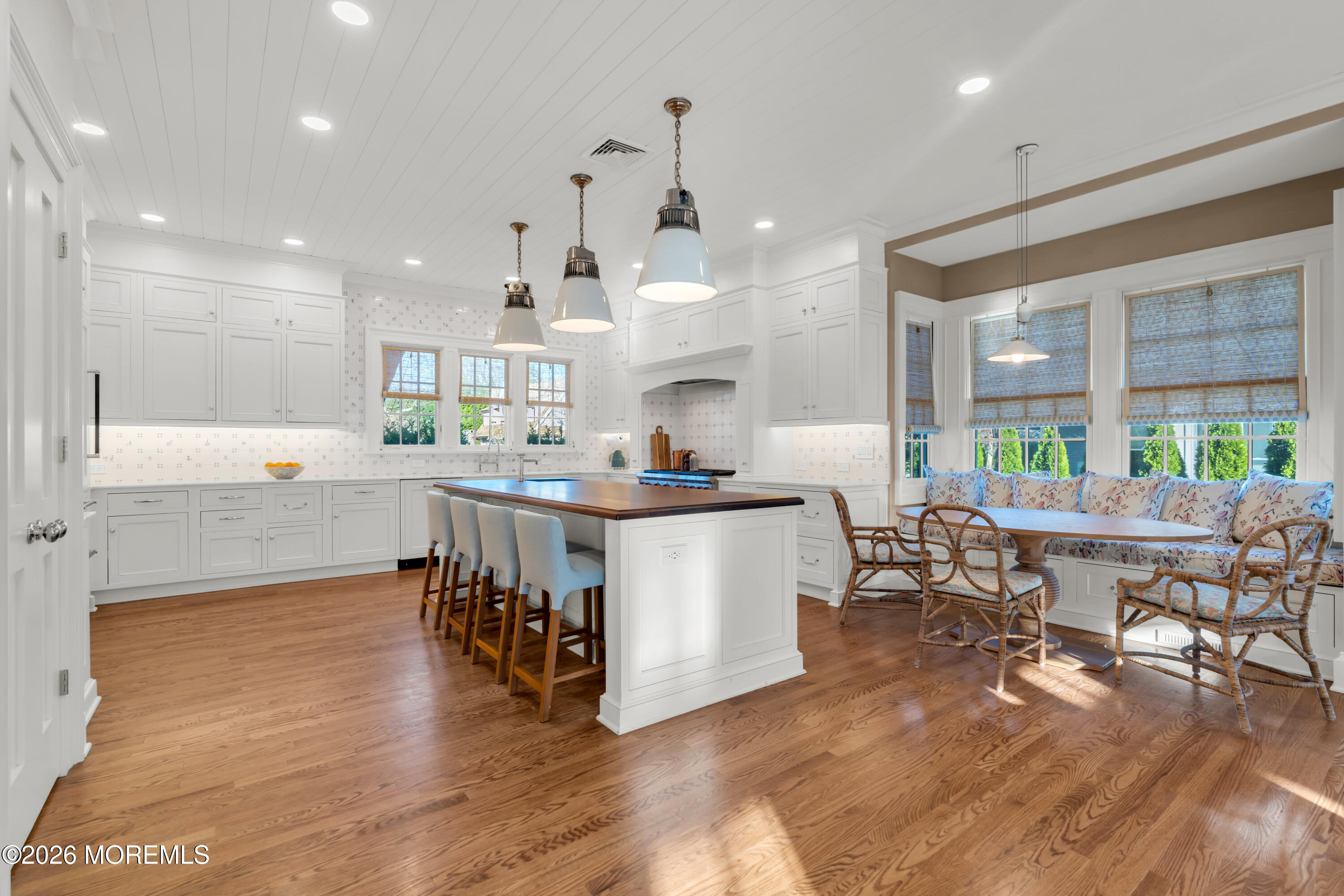 117 Madison Avenue Spring Lake, NJ 07762 - Photo 40 of 96 a large dining hall with stainless steel appliances granite countertop a stove a sink a dining table and chairs with wooden floor