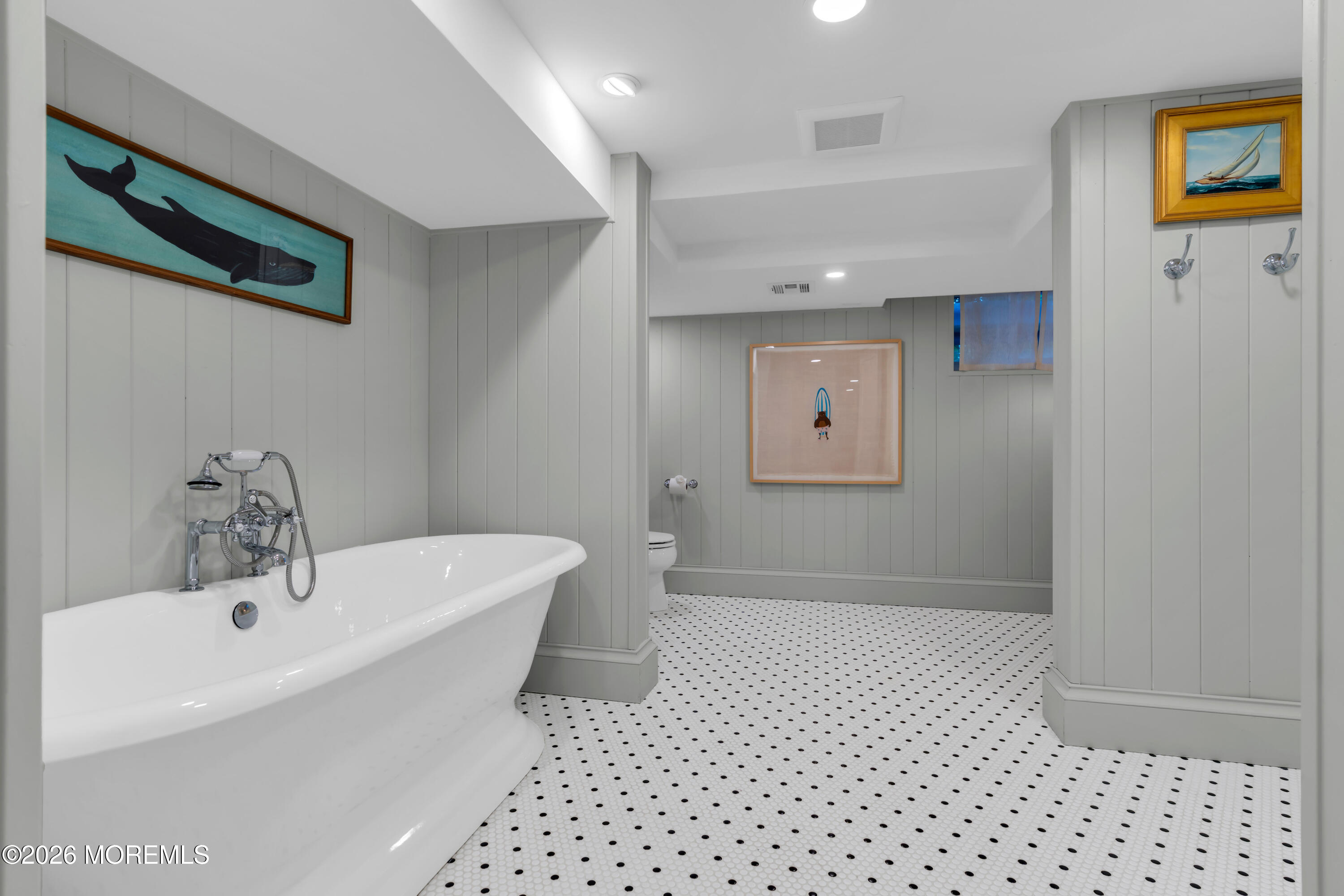 117 Madison Avenue Spring Lake, NJ 07762 - Photo 57 of 96 a bathroom with a bathtub sink and mirror