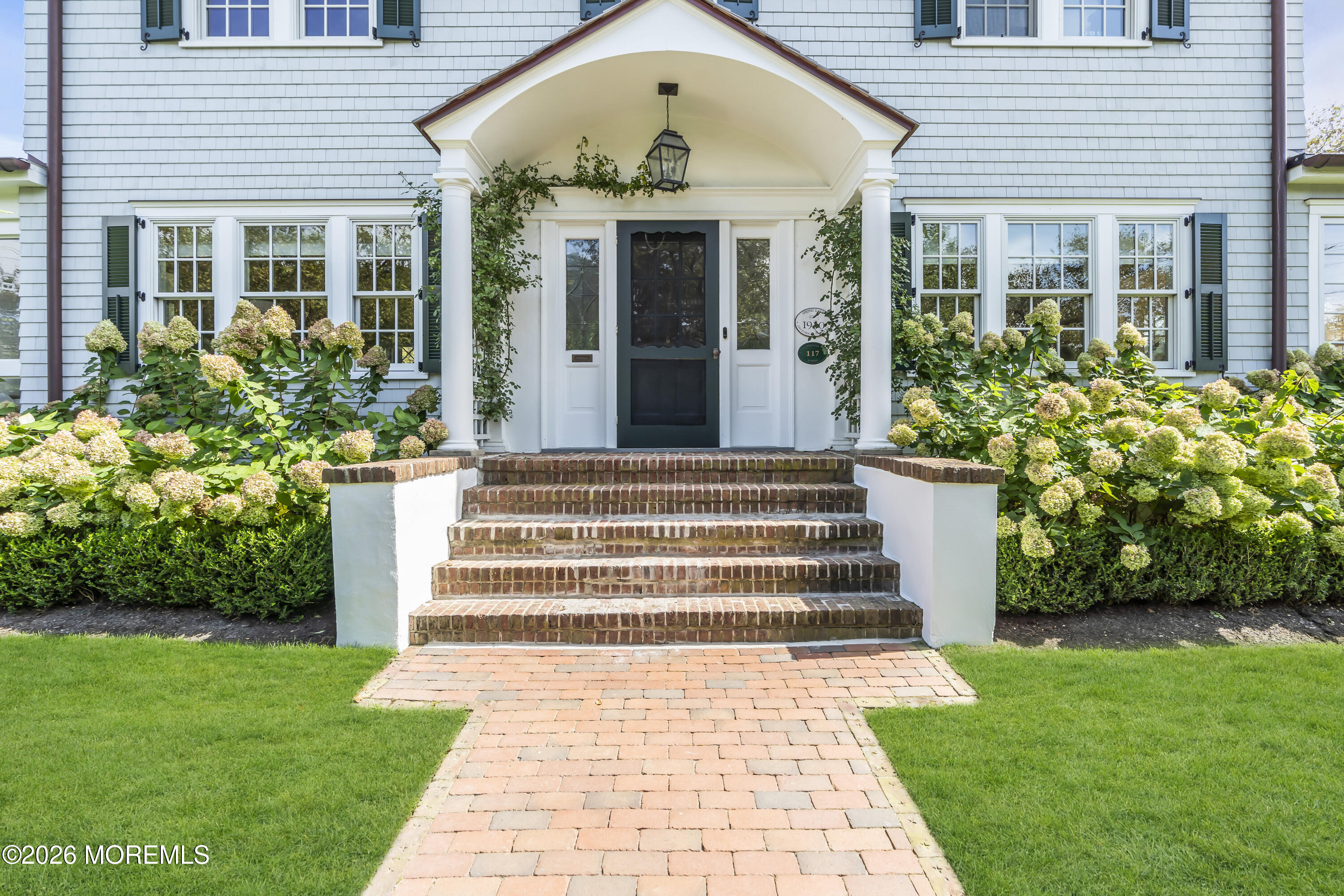 117 Madison Avenue Spring Lake, NJ 07762 - Photo 58 of 96 a front view of a house with garden