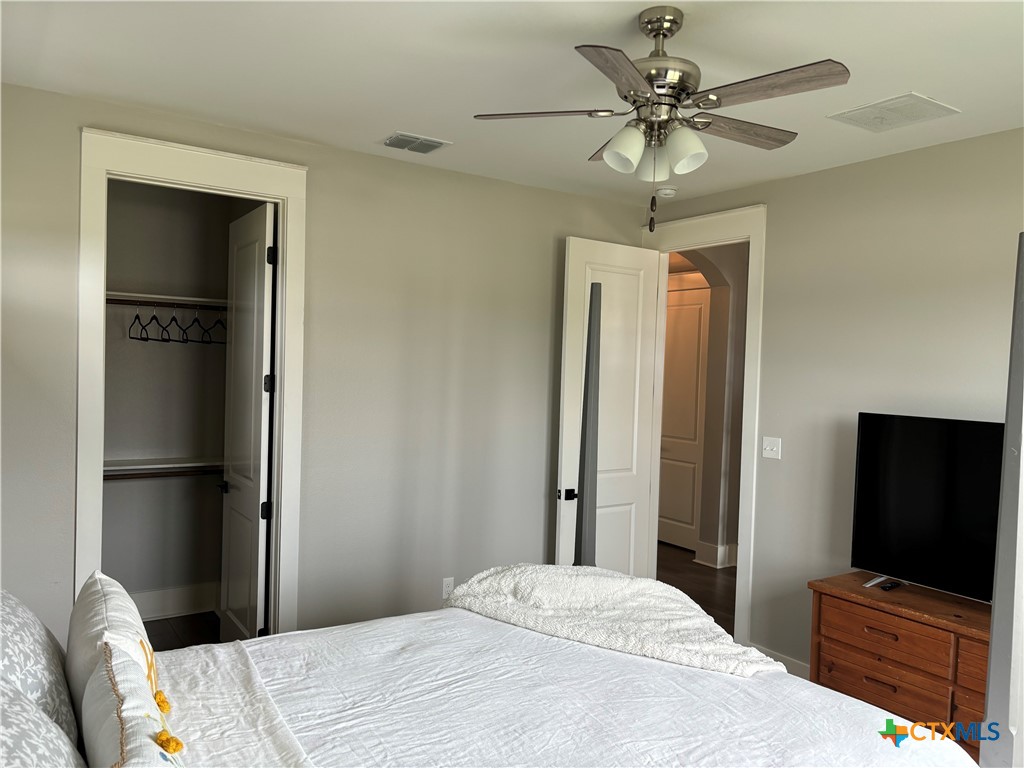 110 Hiram Cook Blanco, TX 78606 - Photo 40 of 46 a bedroom with a bed and a flat screen tv