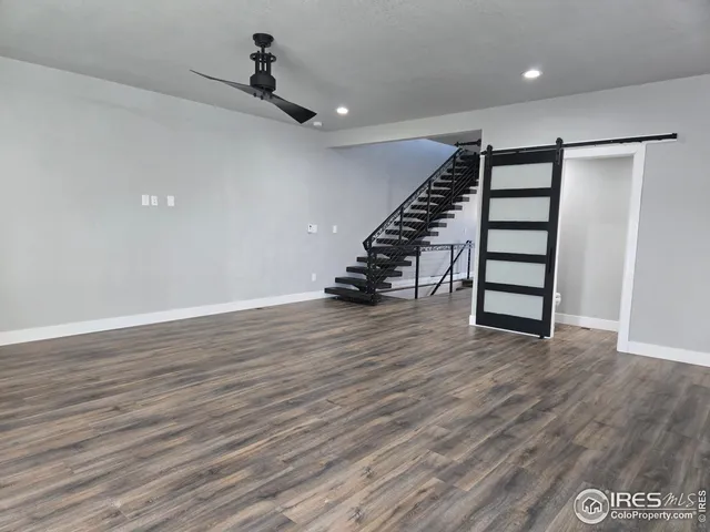 wooden floor in an empty room with stairs