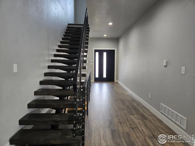wooden floor in an empty room with stairs