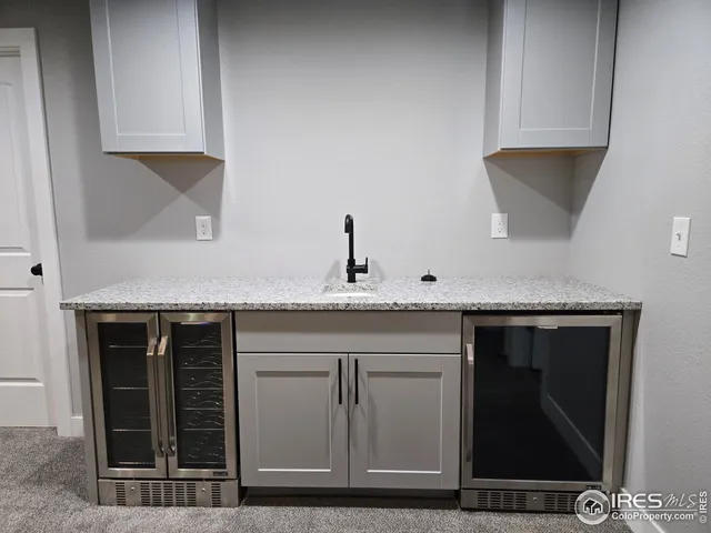 an empty room with windows and fireplace