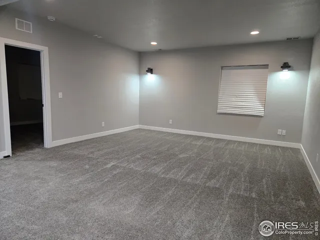 a bathroom with a granite countertop sink toilet a mirror and shower