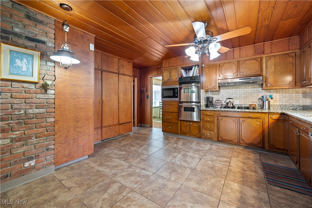 11632 Robson Road Grafton, OH 44044 - Photo 25 of 48 Kitchen with wood ceiling, solid wood cabinetry, double oven, decorative light fixtures, and a ceiling fan