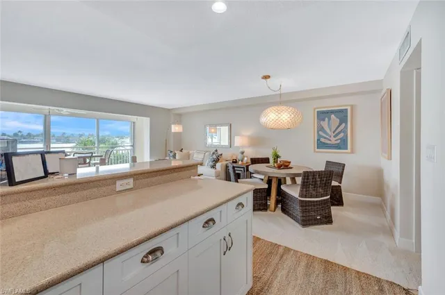 a view of a kitchen with kitchen island granite countertop lots of counter top space