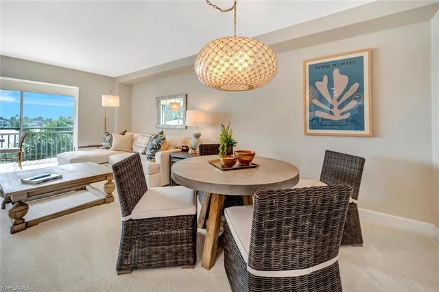 a view of a dining room with furniture wooden floor and a chandelier