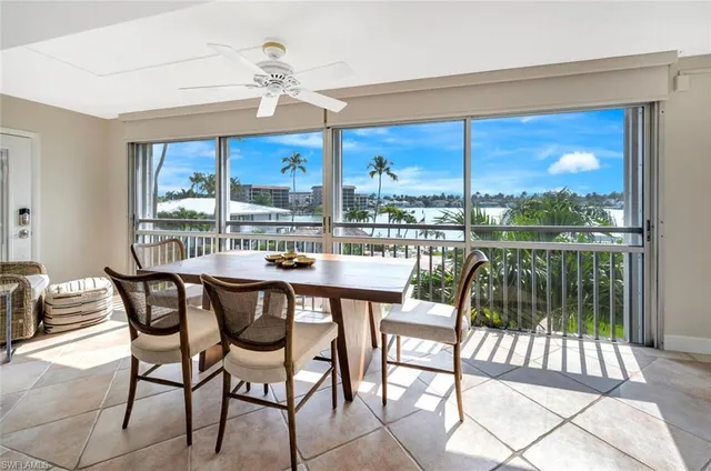 a view of a dining room with furniture large windows and wooden floor