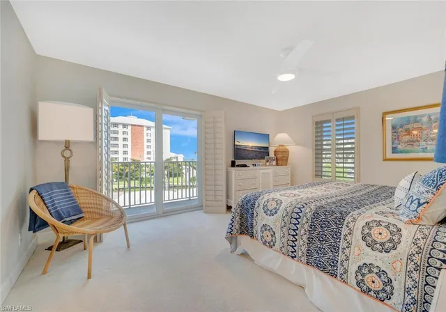 a bed room with a bed and a chair