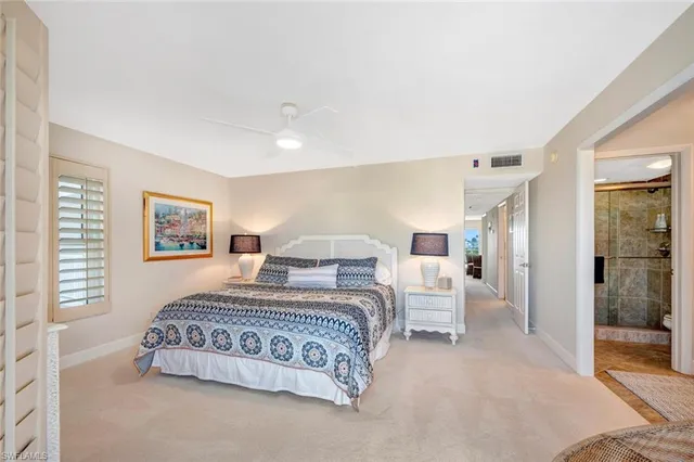 a bedroom with a bed and a night stand