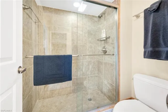a bathroom with a shower and a toilet