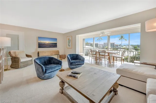 a living room with furniture and a kitchen view