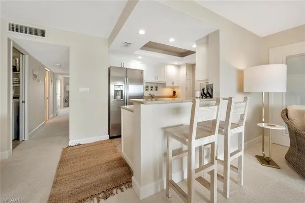 a kitchen with stainless steel appliances granite countertop a refrigerator and a stove top oven