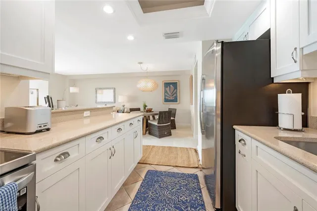 a large kitchen with a lot of counter space and wooden floor