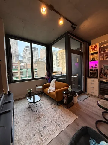 a living room with furniture and a floor to ceiling window