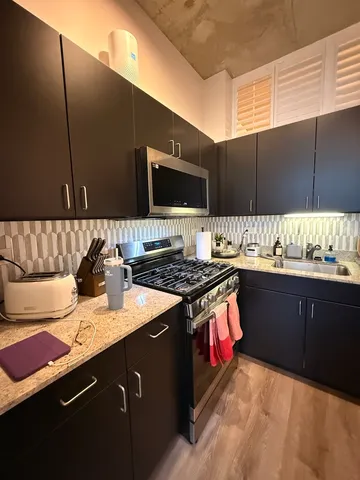 a kitchen with stainless steel appliances granite countertop a stove and a sink