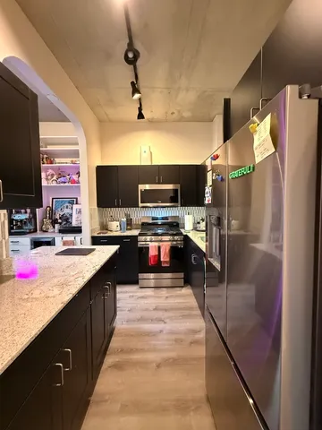 a kitchen with stainless steel appliances granite countertop a sink counter space cabinets and a counter top space