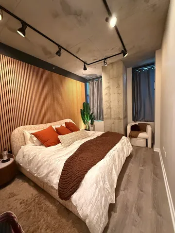 a bedroom with a bed and a mirror