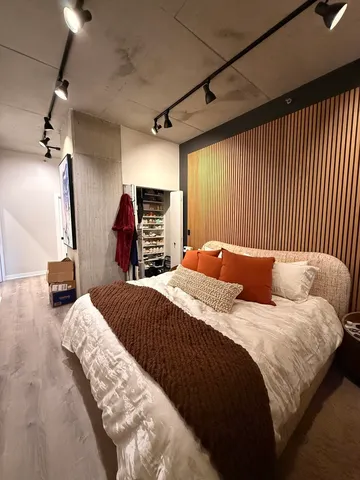 a bedroom with a bed and a large mirror