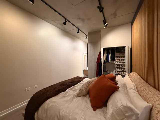 a bedroom with a large bed and a walk in closet