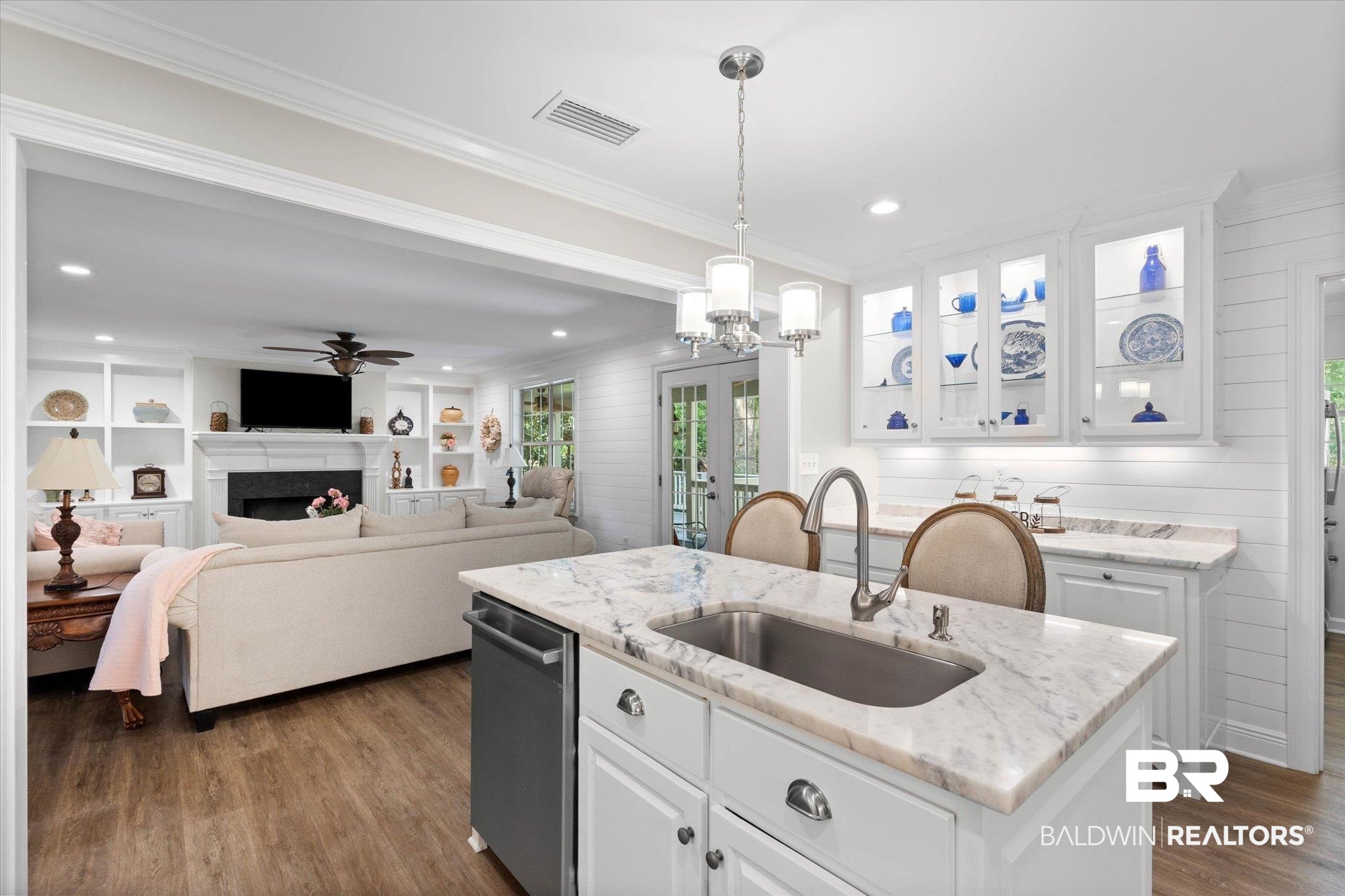 3715 Latigo Road Mobile, AL 36695 - Photo 8 of 39 Kitchen featuring a sink, wood finished floors, white cabinetry, pendant lighting, and crown molding